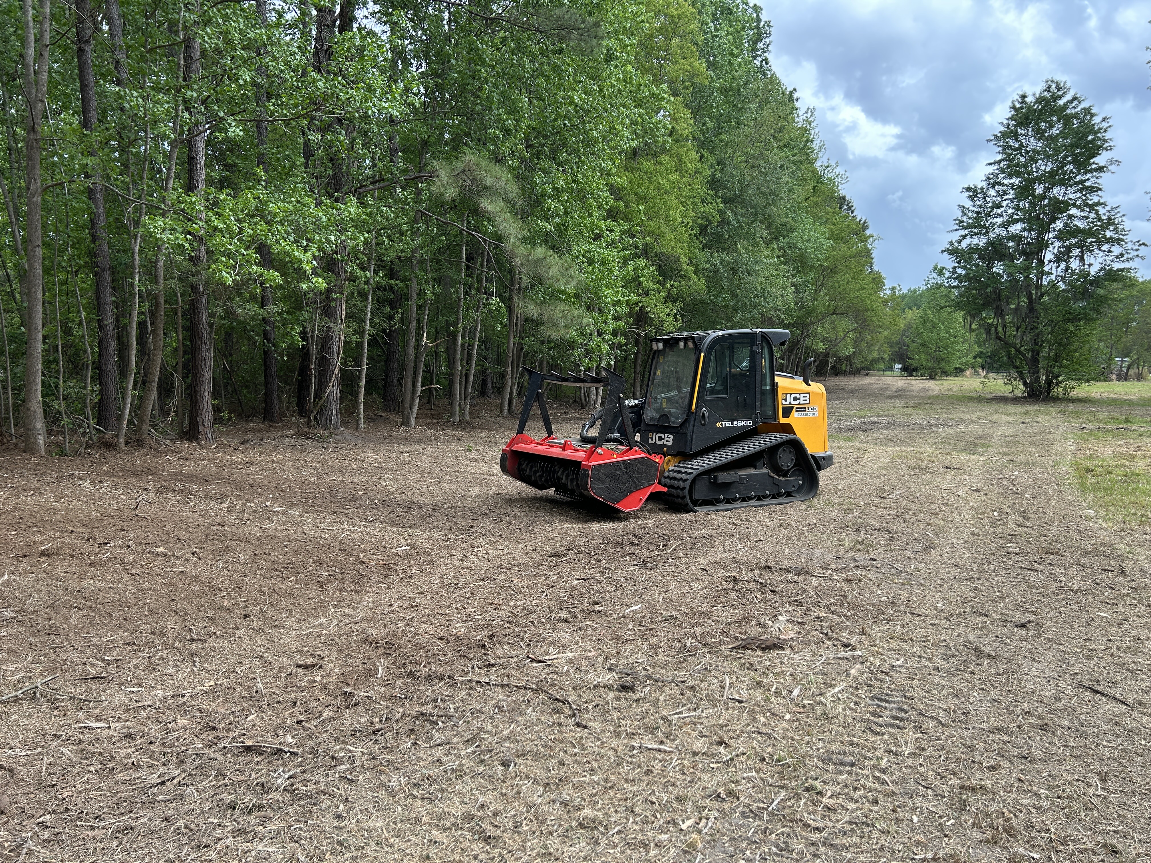 JCB Teleskid with forestry mulcher on a cleared commercial property